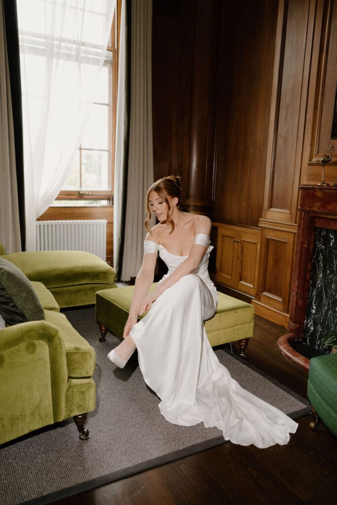 Bride sitting in her wedding dress during preparations at The Edinburgh Grand