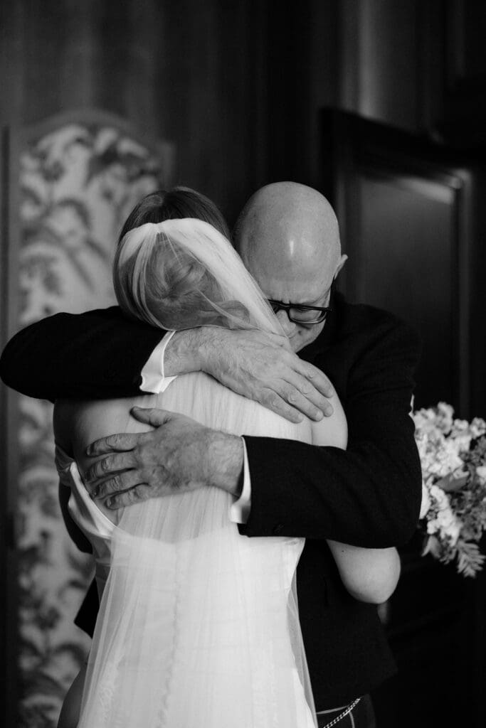 Bride sharing an emotional hug with her father during preparations at The Edinburgh Grand