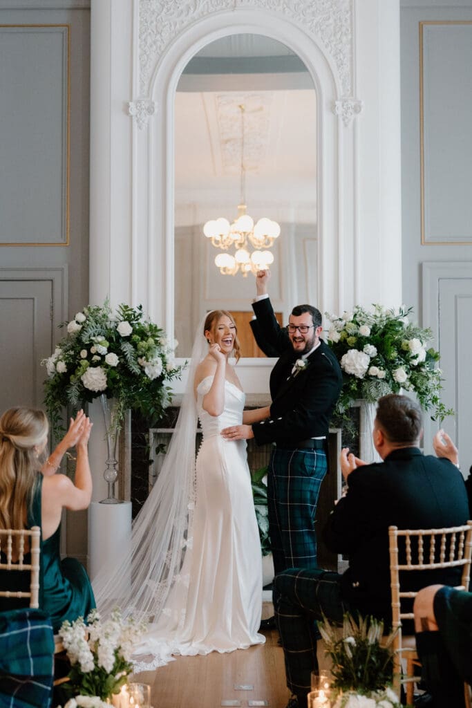 Bride and groom celebrating during their wedding ceremony at The Edinburgh Grand