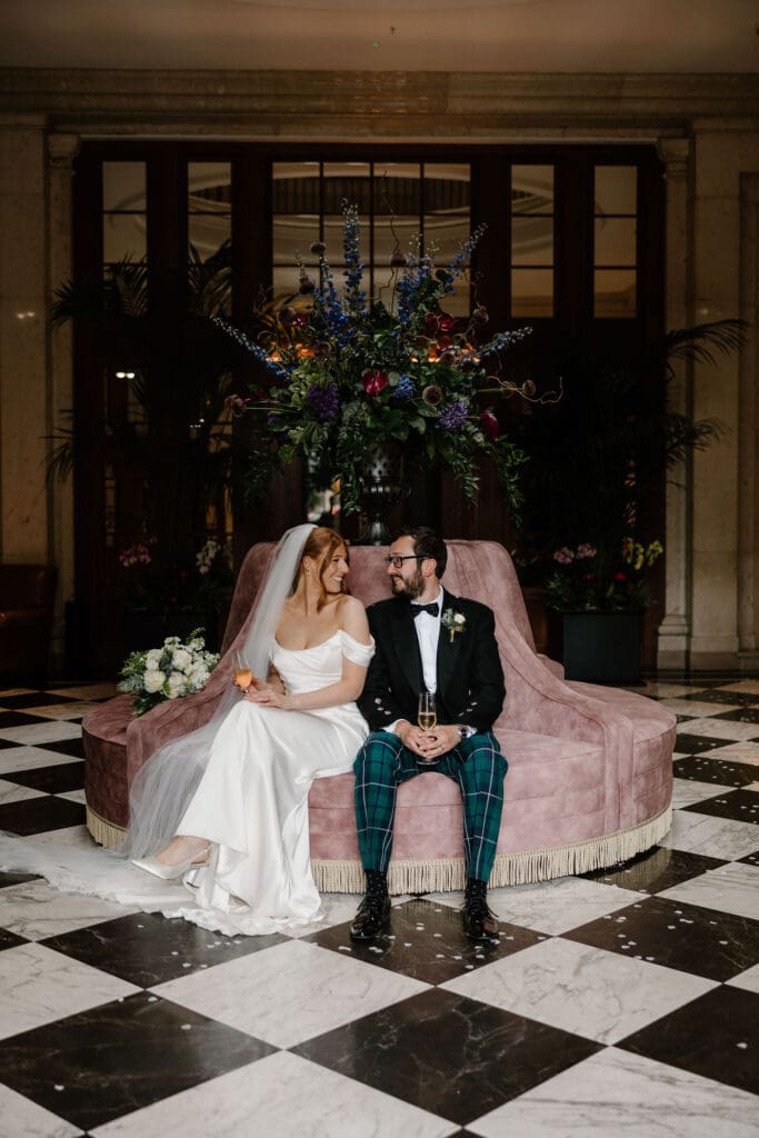 Bride and groom sitting together inside The Edinburgh Grand during their wedding day