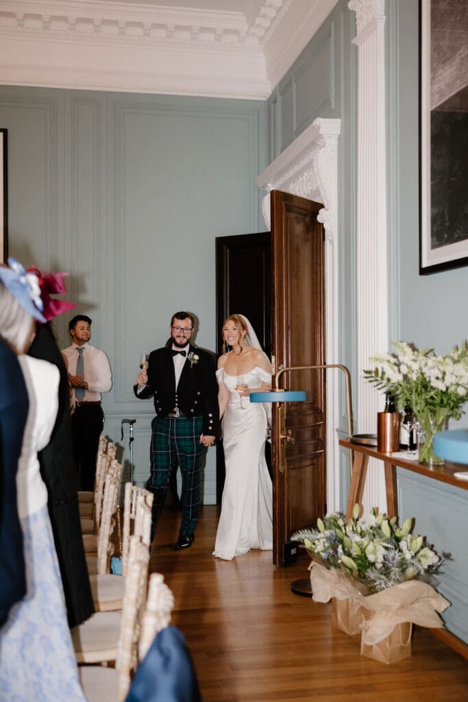 Bride and groom entering the dinner room at The Edinburgh Grand wedding venue