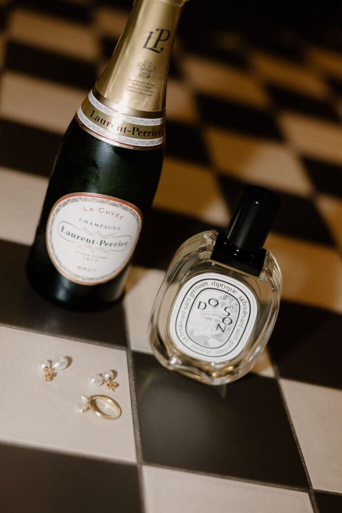 Wedding day details including champagne, perfume and jewellery photographed at The Edinburgh Grand