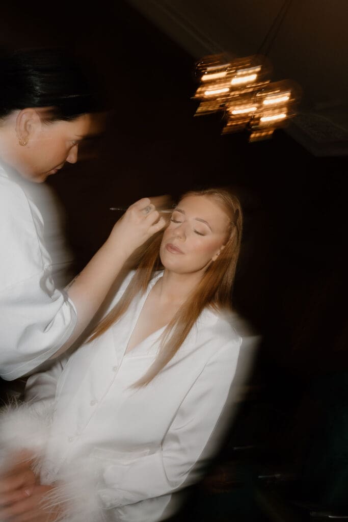 Bride having her makeup applied during preparations at The Edinburgh Grand