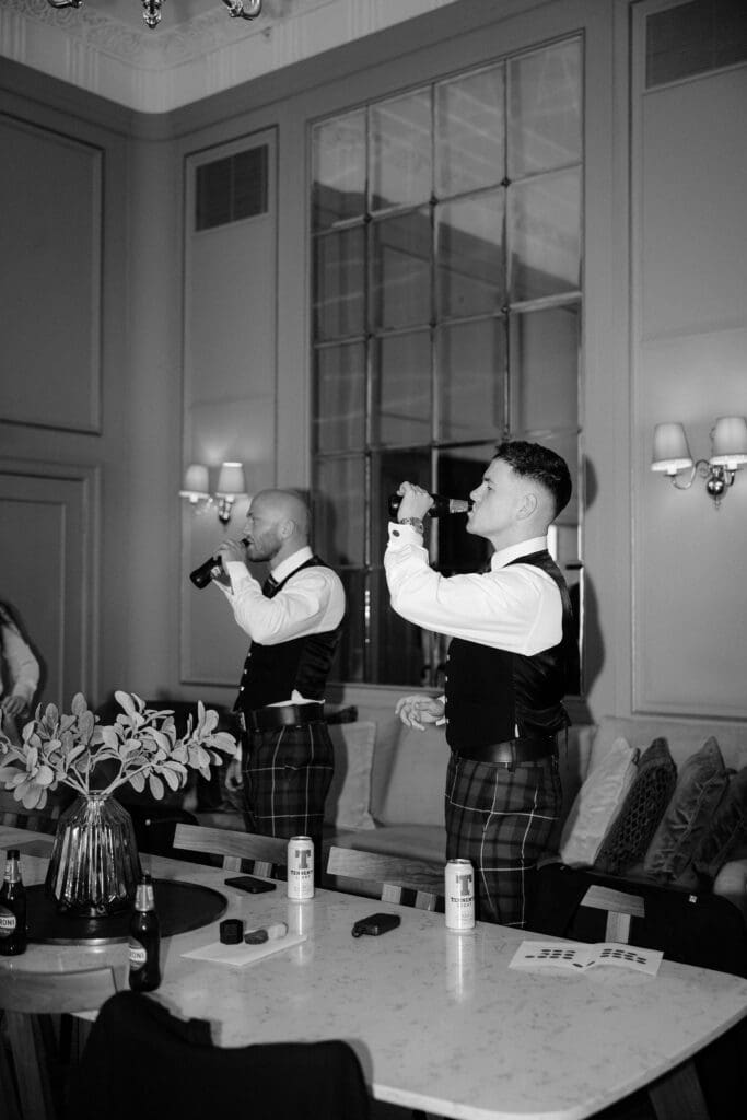 Groomsmen sharing a toast during wedding morning preparations at The Edinburgh Grand