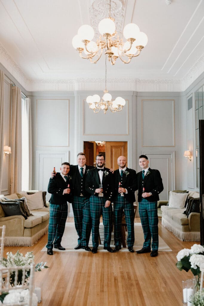 Groom and groomsmen standing together during preparations at The Edinburgh Grand
